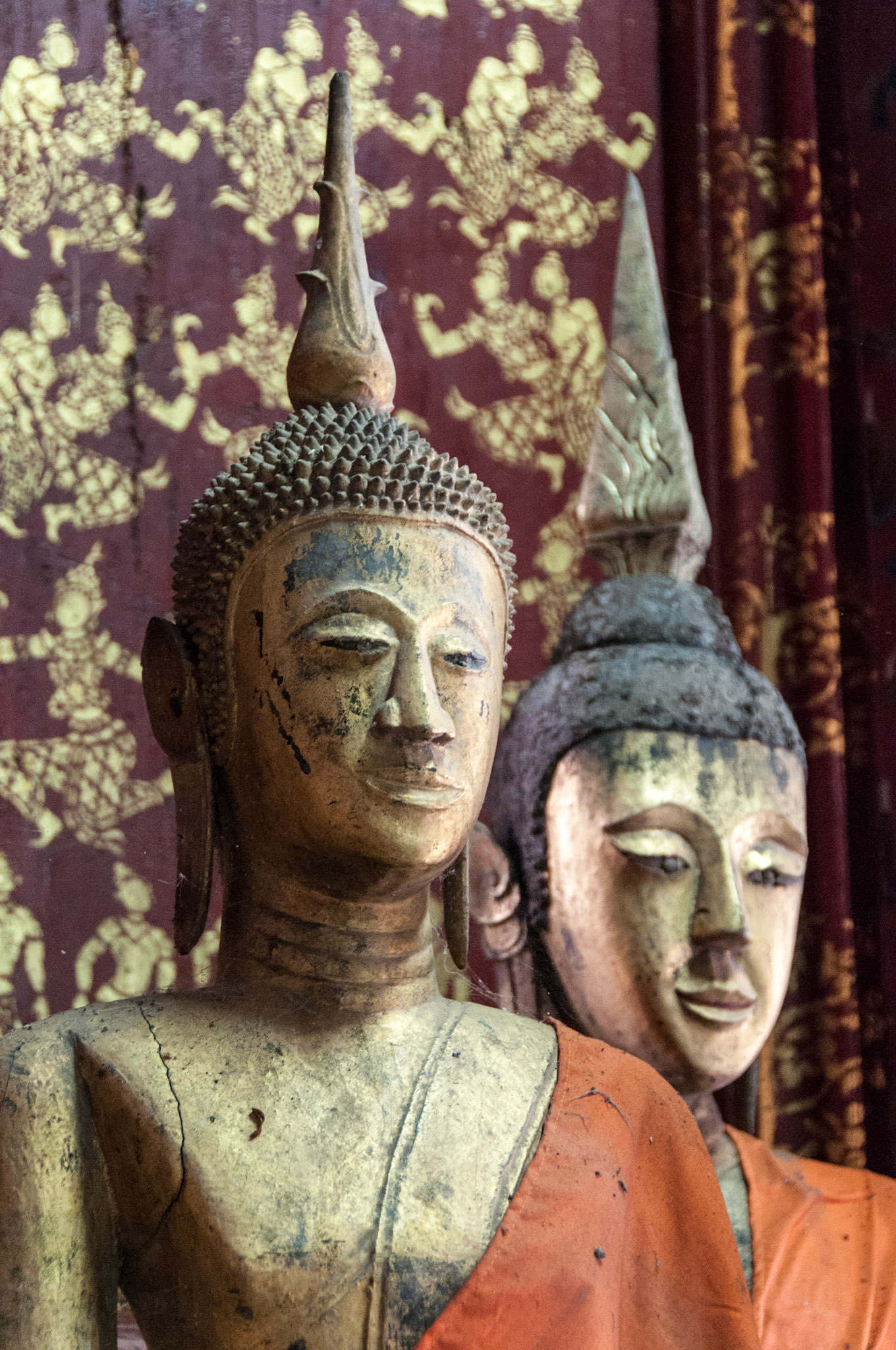 Laos, Luang Prabang, Wat Xieng Thong, carved wooden images of monks in the temple building that houses the funeral chariot.
