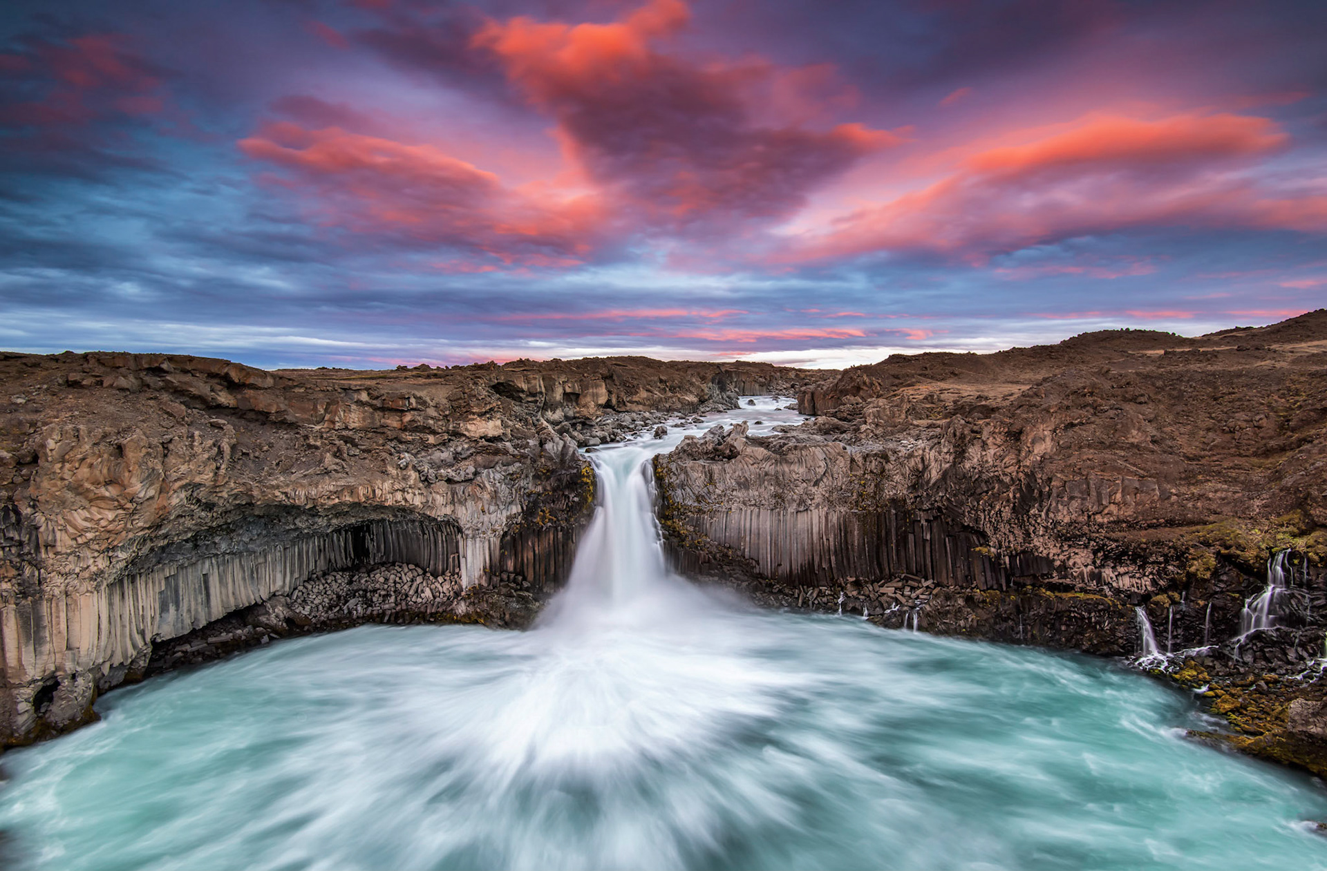 This is the Aldeyjarfoss, an enormous waterfall flowing between a canyon of basalt formations.