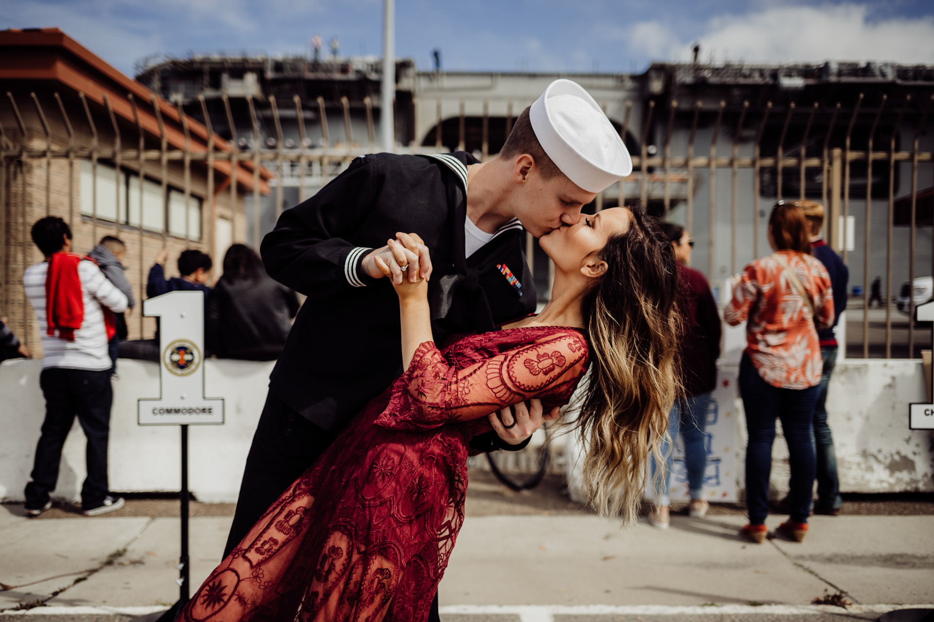 Sailor kissing Fiance at Military Navy Homecoming Coronado Naval Base San Diego by Morning Owl Fine Art Photography